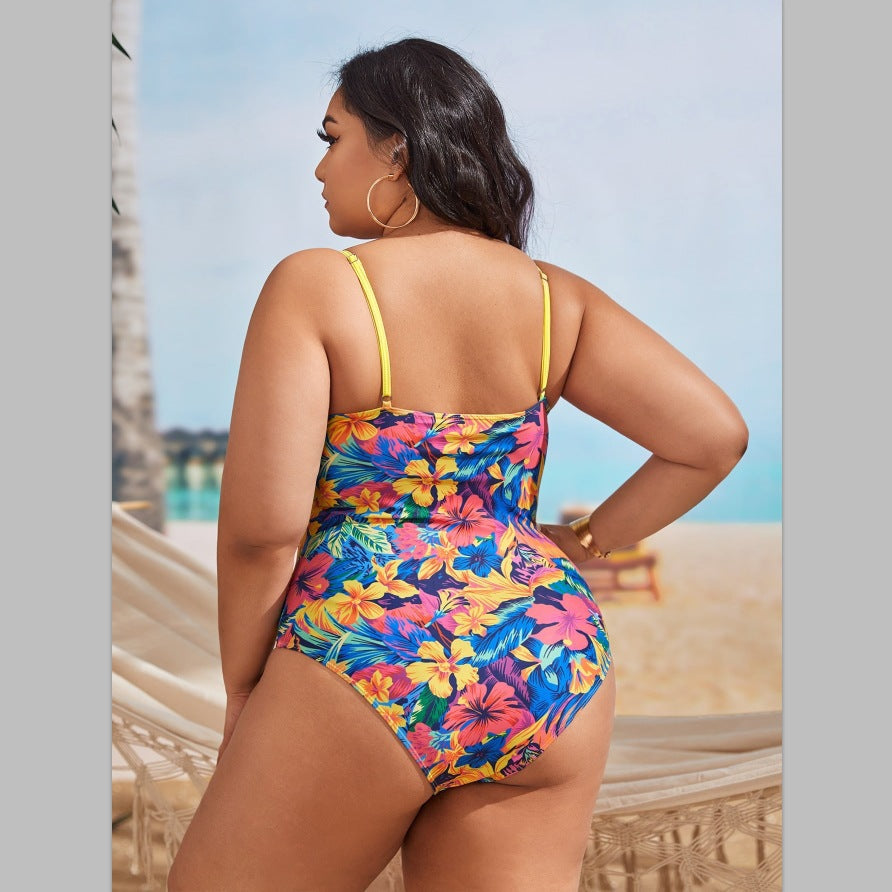 Women's one-piece swimsuit with asymmetrical ruffle design and floral pant area StylebySassy