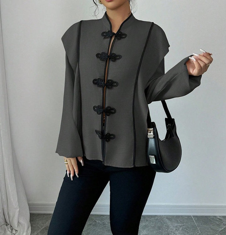 Women's stand-up collar blouse with decorative knot closures and decorative piping StylebySassy