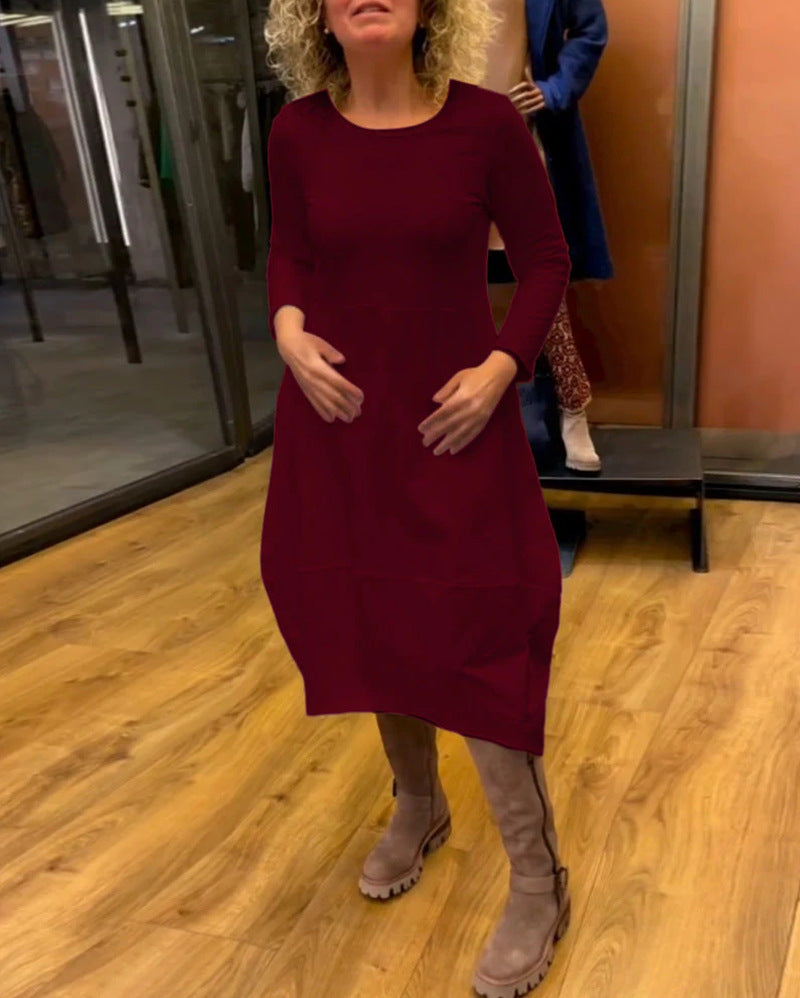 Women's asymmetrical balloon dress with three-quarter sleeves, side pockets, and flowing pointed hem StylebySassy
