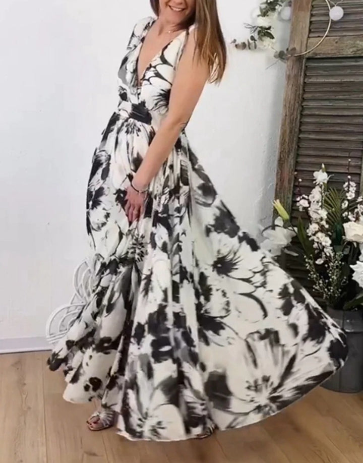 Women’s voluminous A-line maxi dress with deep V-neck, tailored tie belt and large floral brush print StylebySassy