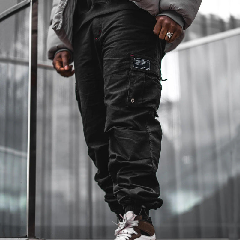 Men's multi-pocket casual trousers made of cotton twill with tapered leg and adjustable ankle drawstring StylebySassy