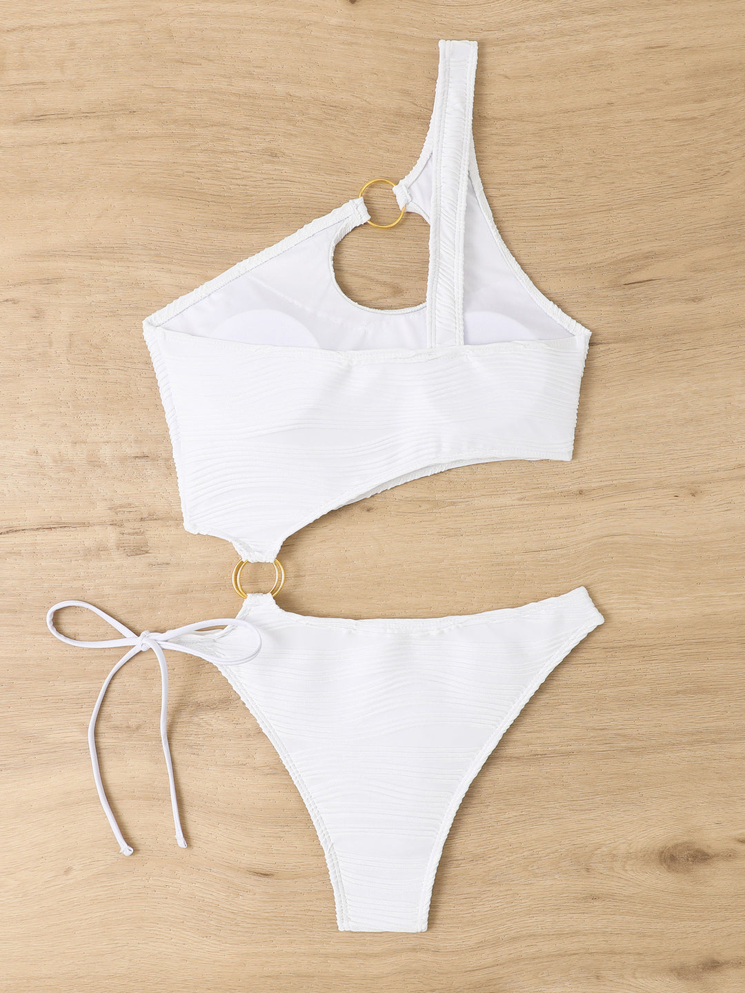 Women's one-piece swimsuit with asymmetrical cut-out and golden accents StylebySassy