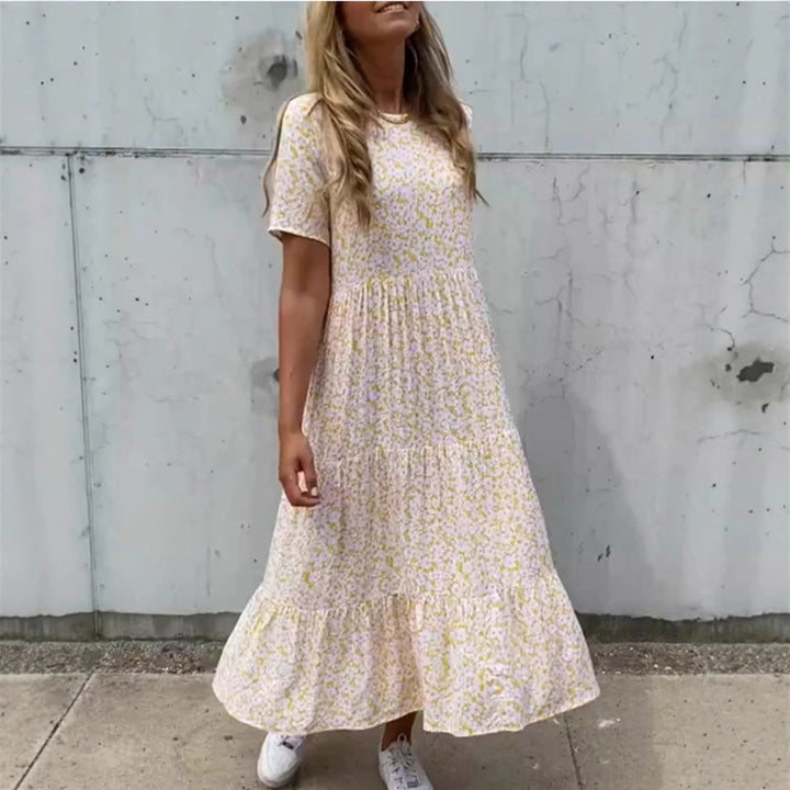 Women's flowing tiered maxi dress in Boho babydoll style with gathered underbust and short sleeves StylebySassy