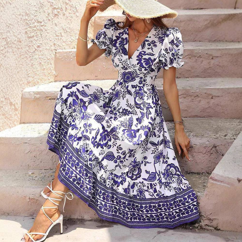 Women’s boho-inspired maxi dress with gathered empire waist, short puff sleeves, and decorative border print StylebySassy