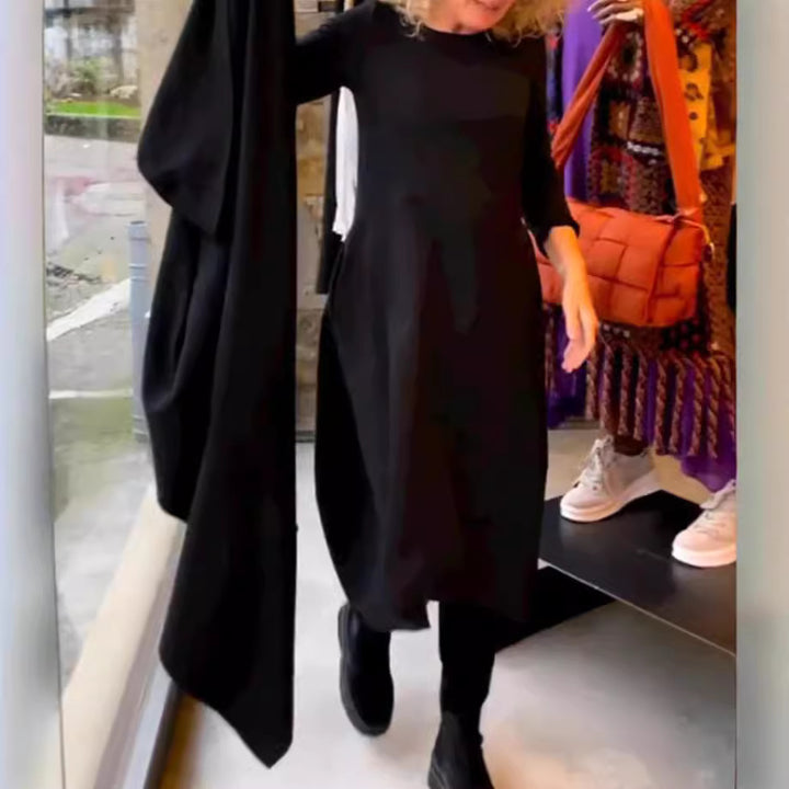 Women's asymmetrical balloon dress with three-quarter sleeves, side pockets, and flowing pointed hem StylebySassy
