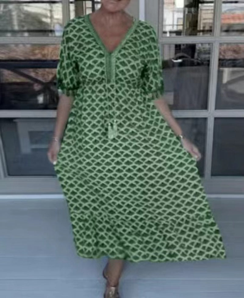 Women's casual midi dress in kaftan style with V-neck, tassel band, gathered empire seam, and fringe sleeves StylebySassy