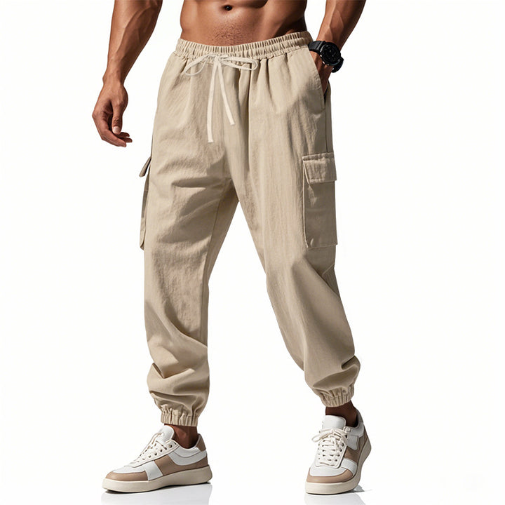 Men's tapered joggers in utilitarian style with elastic waistband, drawstring, and flap pockets StylebySassy