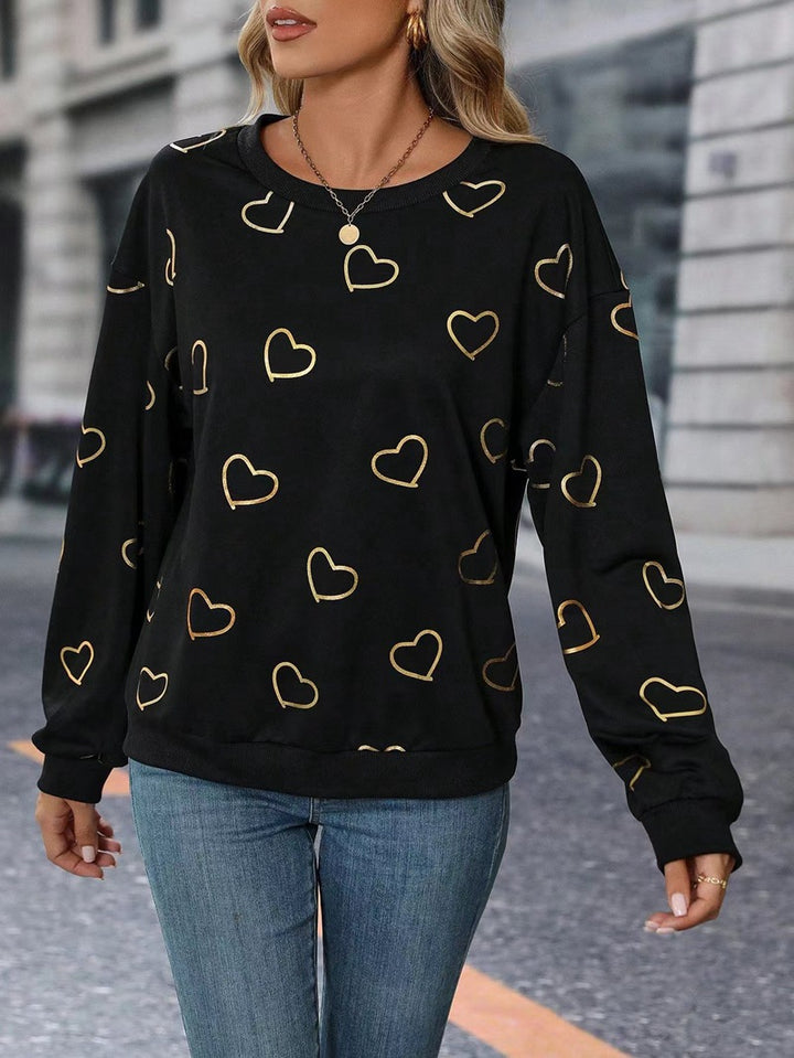 Women's loose heart print sweatshirt with round neck and ribbed cuffs StylebySassy