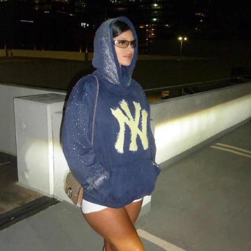 Women's oversized hoodie made of velvet fleece with distinctive logo print, glitter trim, and kangaroo pocket StylebySassy