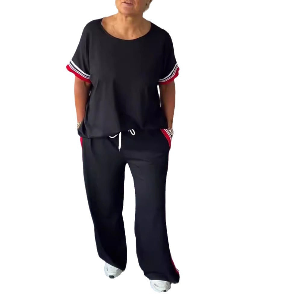 Ladies' sporty-elegant two-piece set with boxy short sleeve shirt, drawstring jog pants, and side contrast stripe StylebySassy