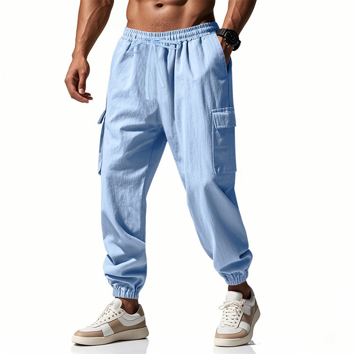 Men's tapered joggers in utilitarian style with elastic waistband, drawstring, and flap pockets StylebySassy