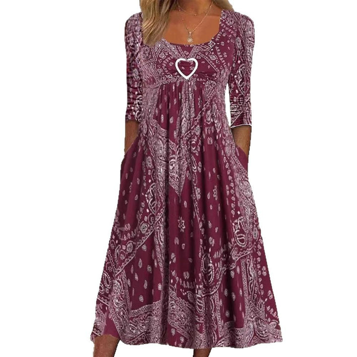 Women's maxi dress with paisley bandana pattern, empire seam, gathered underbust area, and side pockets StylebySassy