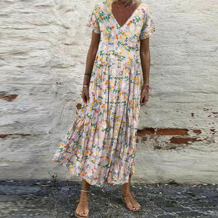 Women’s V-neck maxi dress with fine pleated skirt, empire bodice and short sleeves StylebySassy