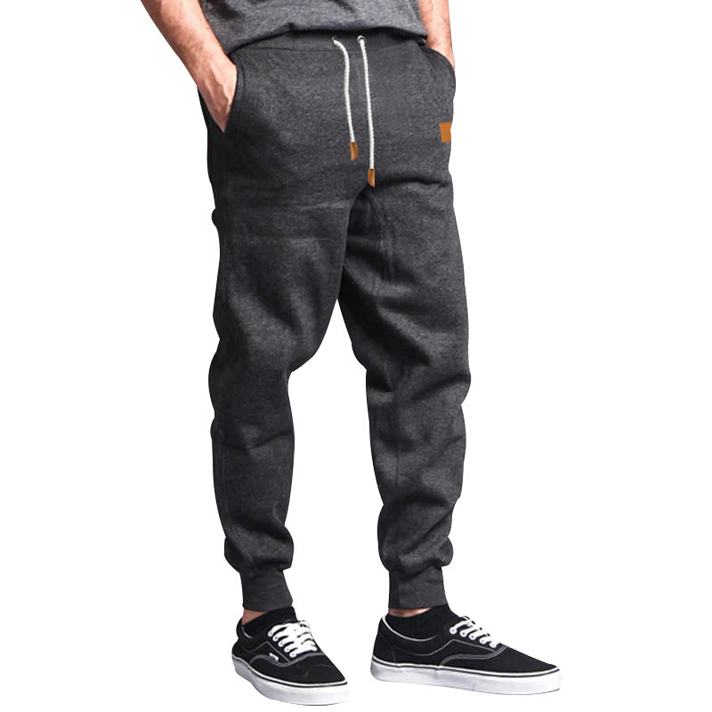 Men's tapered leisure pants made of sweat fabric with elastic waistband, drawstring, and ribbed cuffs StylebySassy
