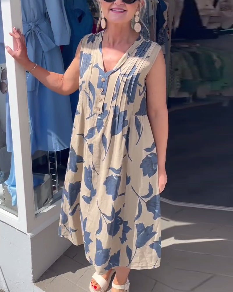 Women's sleeveless A-line midi dress with V-neck, bust pleats, button placket, and large floral print StylebySassy