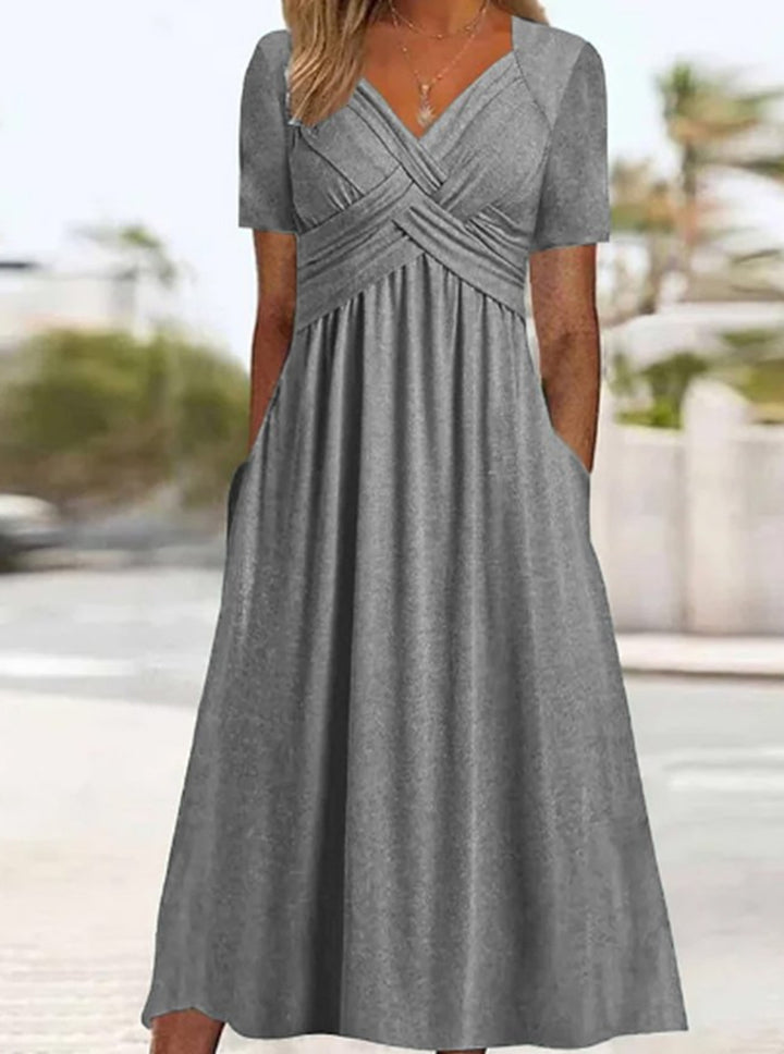 Women's airy midi dress with V-neck, wrap look, empire waist, and pockets StylebySassy