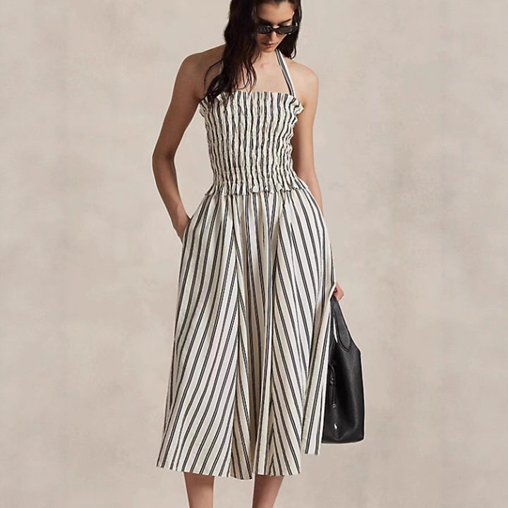 Women's midi dress with smocked bodice, adjustable halter strap, wide A-line skirt and side pockets StylebySassy