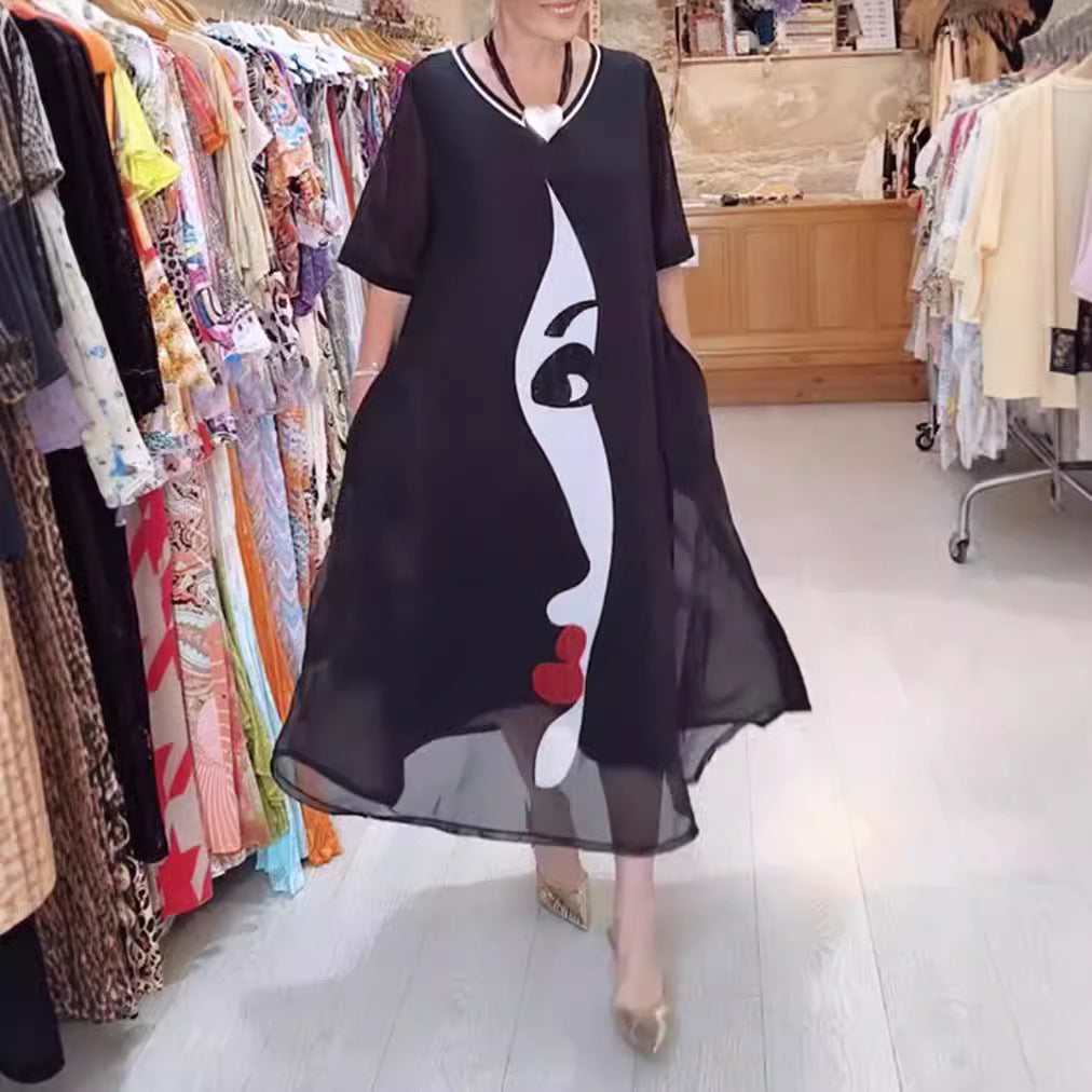 Women's airy chiffon maxi dress with graphic face print, V-neck and side pockets StylebySassy