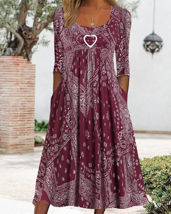 Women's maxi dress with paisley bandana pattern, empire seam, gathered underbust area, and side pockets StylebySassy