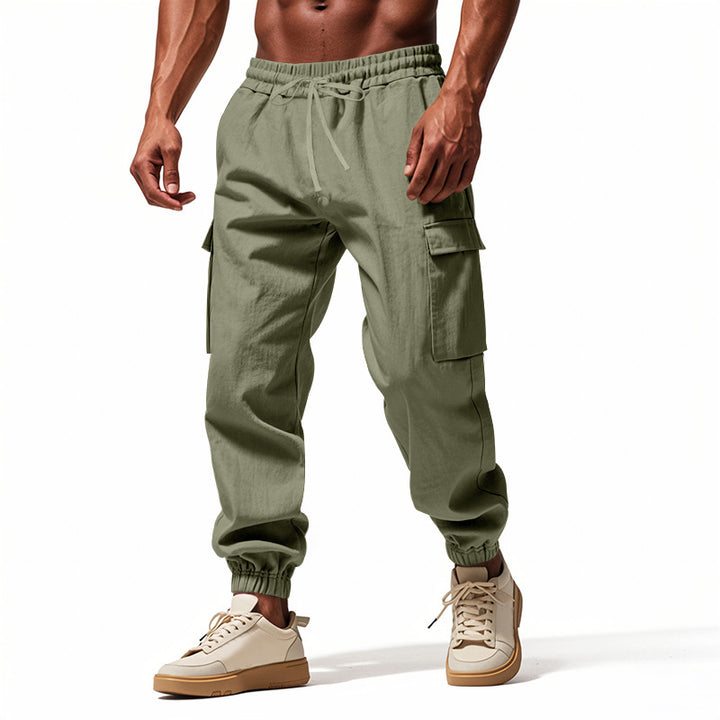Men's tapered joggers in utilitarian style with elastic waistband, drawstring, and flap pockets StylebySassy