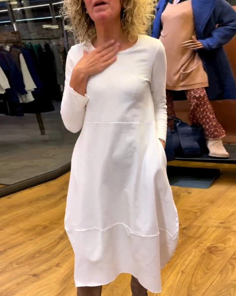 Women's asymmetrical balloon dress with three-quarter sleeves, side pockets, and flowing pointed hem StylebySassy