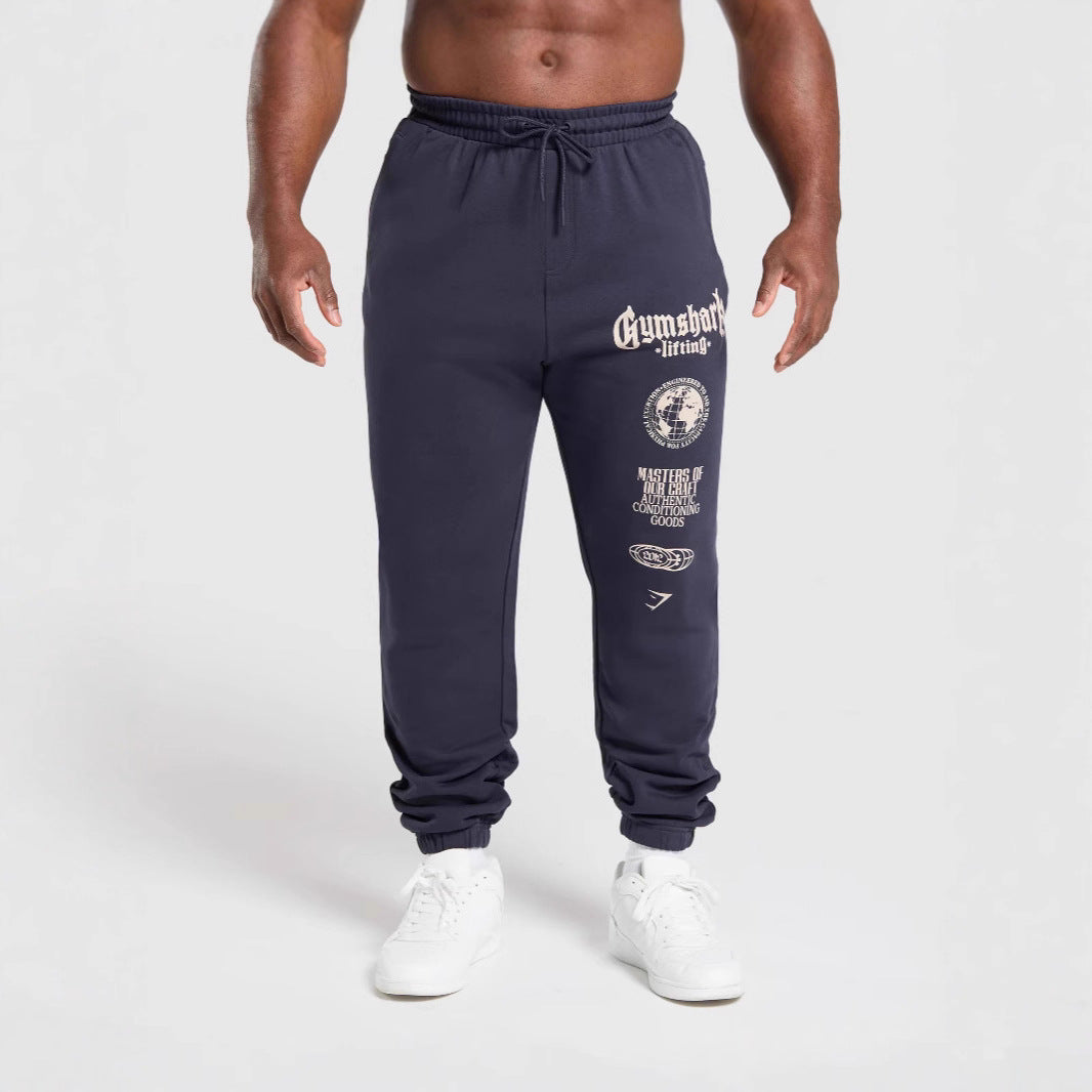 Men's tapered cotton fleece sweatpants with an elastic drawstring waistband, ribbed leg openings, and large logo print StylebySassy