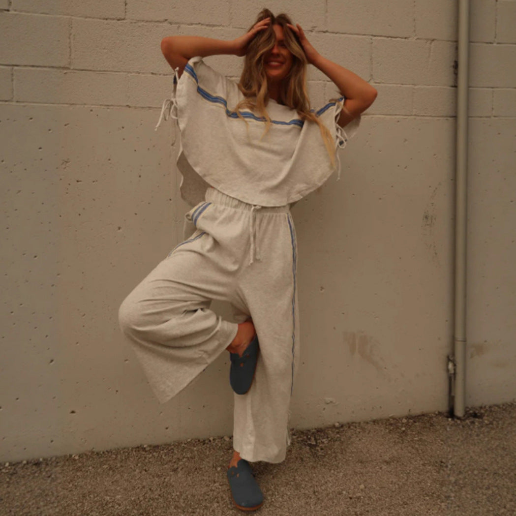 Ladies two-piece leisure ensemble with boxy ruffle top and wide cord pants with side decorative stripe StylebySassy