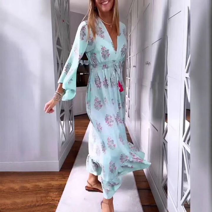 Women’s airy-flowing Boho midi dress with V-neck, gathered smock waist, drawstring with tassels, and asymmetrical ruffled hem StylebySassy