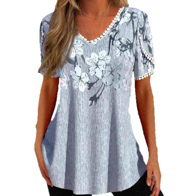 Women's flowing V-neck tunic top with floral print pompom trim and A-line cut StylebySassy