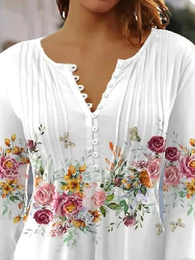 Ladies airy tunic blouse with watercolor floral border, knife pleats, and three-quarter sleeves StylebySassy