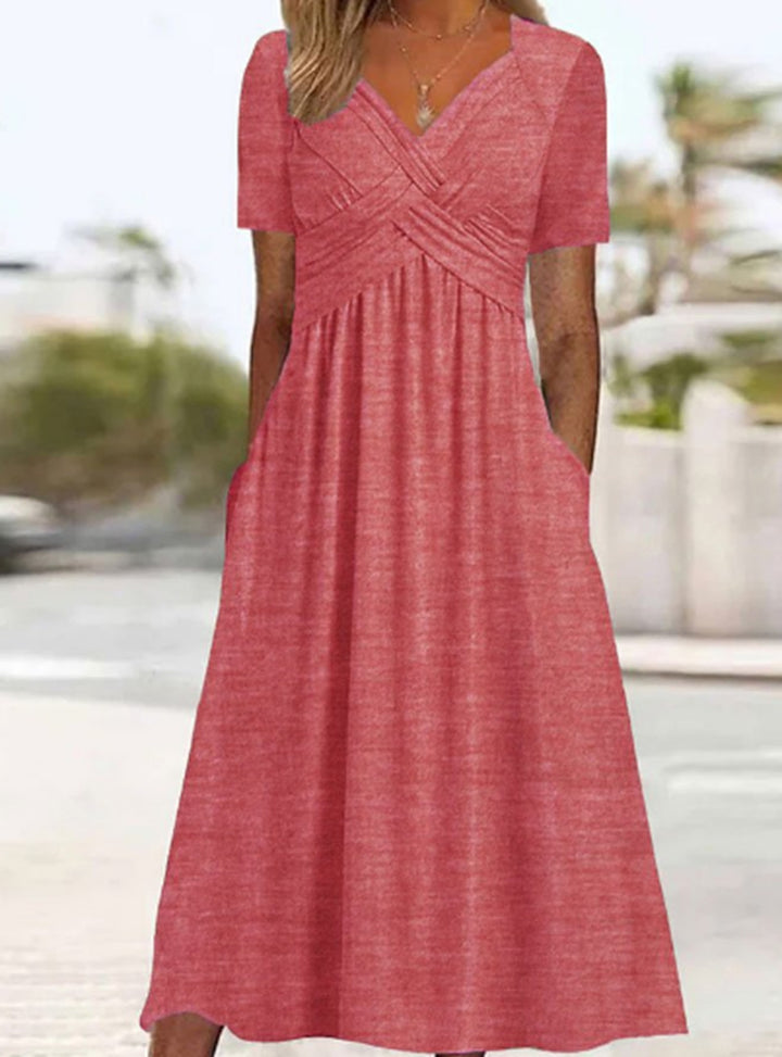 Women's flowing maxi dress with crossed yoke V-neck short sleeves and side pockets StylebySassy