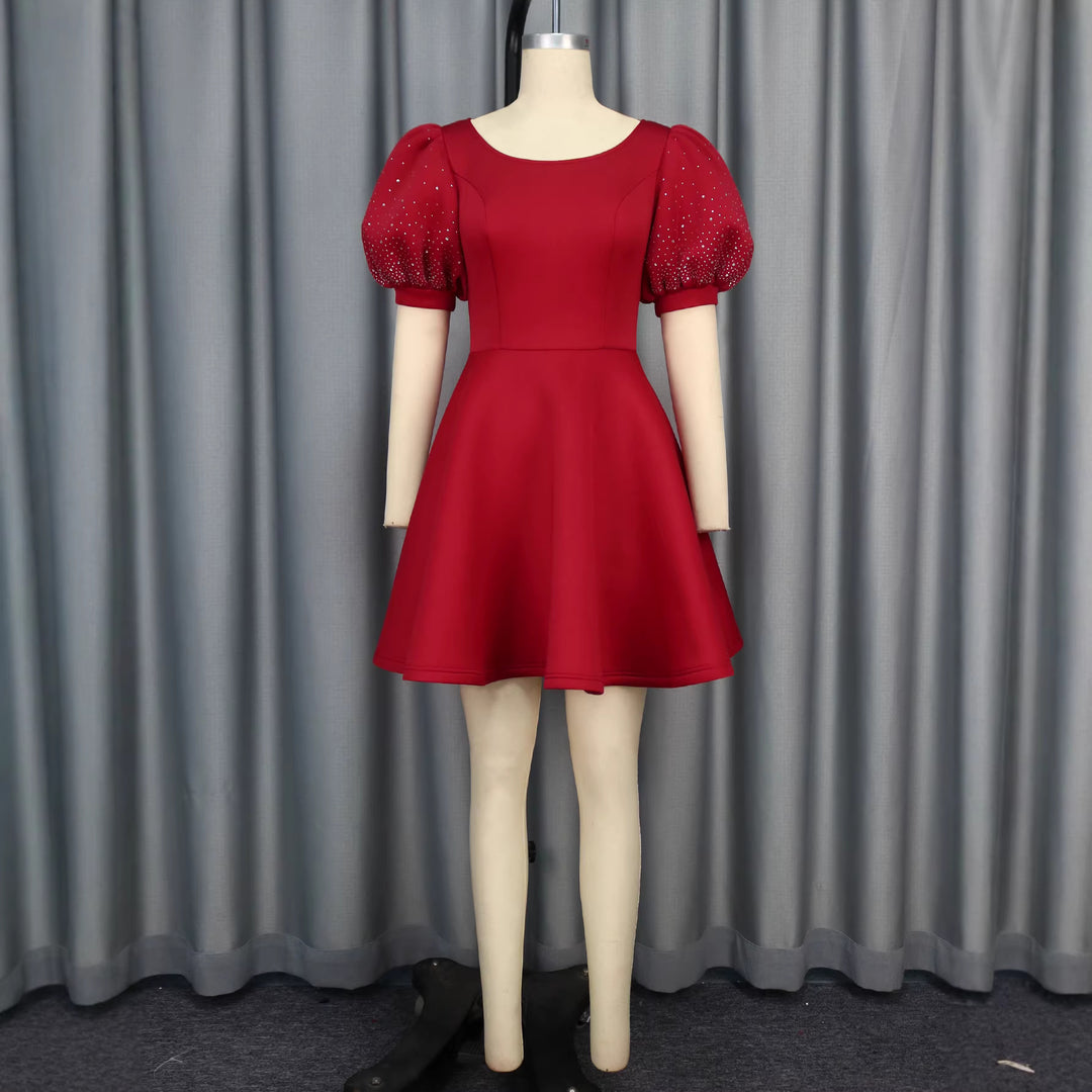 Women's cocktail dress with voluminous puff sleeves and shimmering accents StylebySassy