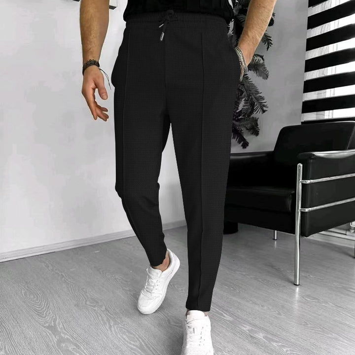 Men's tapered jogging chinos made of structured woven quality with elastic drawstring waistband and decorative crease StylebySassy