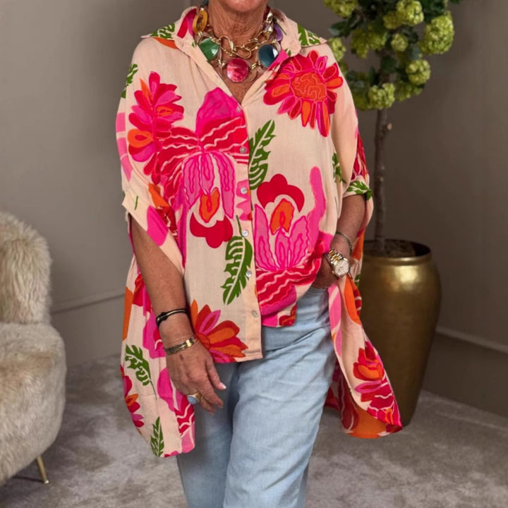 Women's airy oversized resort-style shirt blouse with large floral print and asymmetrical scalloped hem StylebySassy