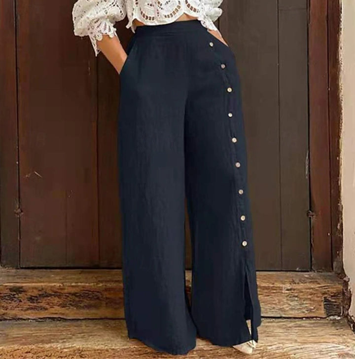 Women's high-waisted linen trousers with a side decorative button placket, side pockets, and wide leg cut StylebySassy