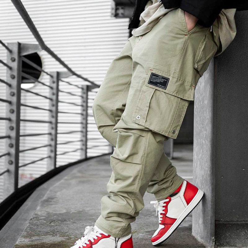 Men's multi-pocket casual trousers made of cotton twill with tapered leg and adjustable ankle drawstring StylebySassy