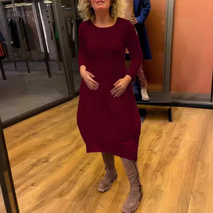 Women's asymmetrical balloon dress with three-quarter sleeves, side pockets, and flowing pointed hem StylebySassy