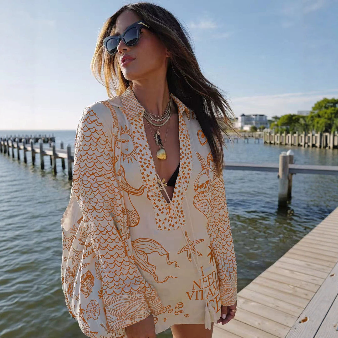 Ladies lightweight beach cover-up in tunic form with deep V-neck, tassel closure, and nautical ocean print StylebySassy