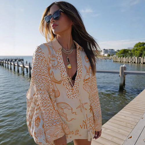 Ladies lightweight beach cover-up in tunic form with deep V-neck, tassel closure, and nautical ocean print StylebySassy