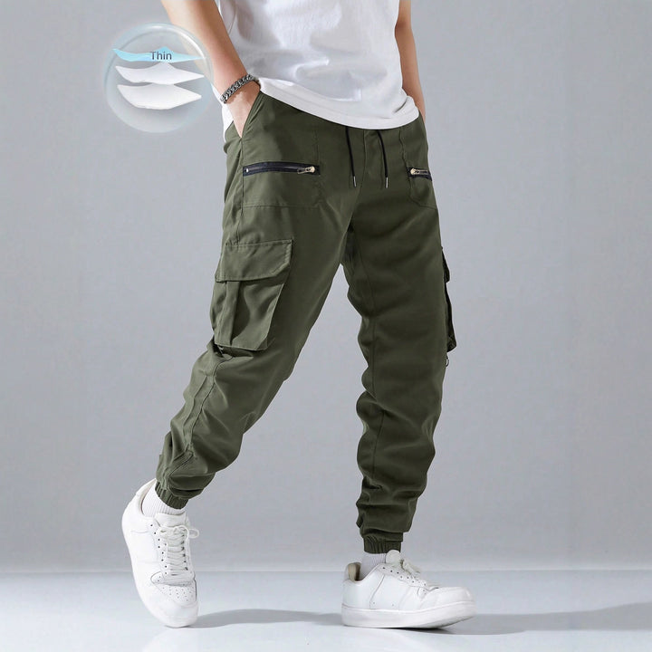Men's slim cargo joggers with multiple zippered pockets, elastic ankle cuff, and drawstring StylebySassy