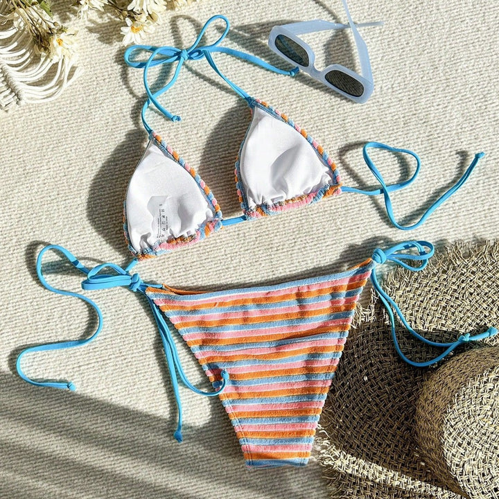 Women's bikini model with playful striped pattern StylebySassy