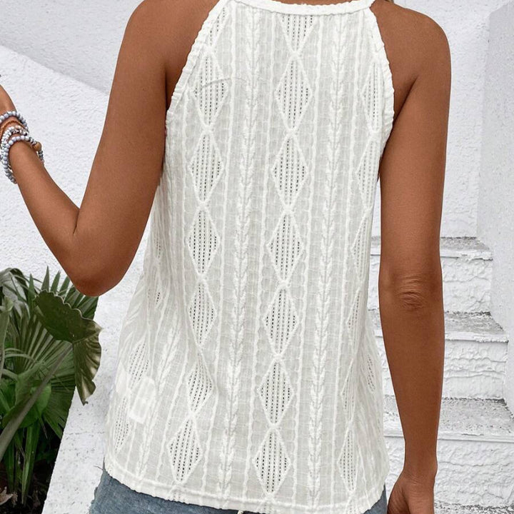 Women's airy lace-knit top with high halter neck, sleeveless fit, and loose hem StylebySassy