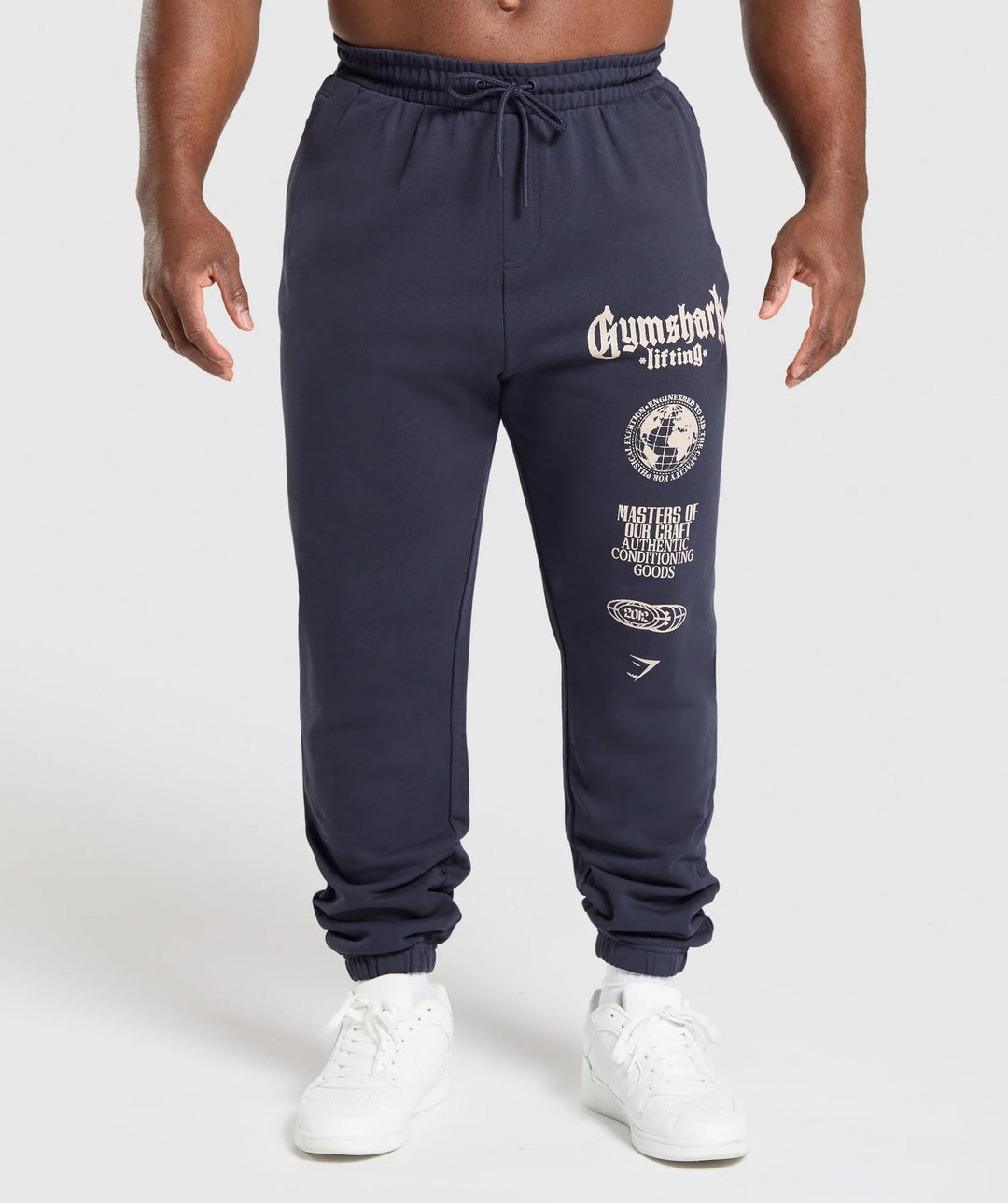Men's tapered cotton fleece sweatpants with an elastic drawstring waistband, ribbed leg openings, and large logo print StylebySassy