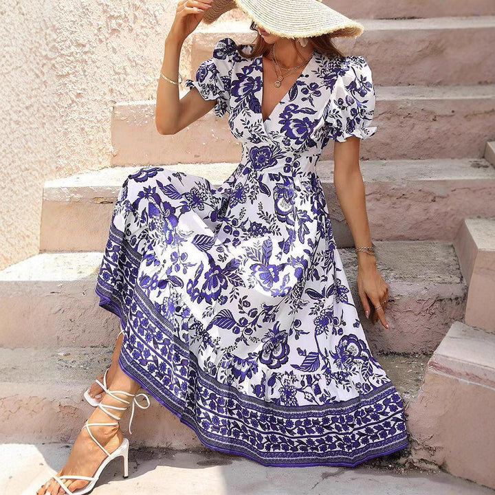 Women’s boho-inspired maxi dress with gathered empire waist, short puff sleeves, and decorative border print StylebySassy