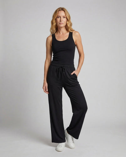 Women's A-line tiered dress with crepe texture and side pockets.