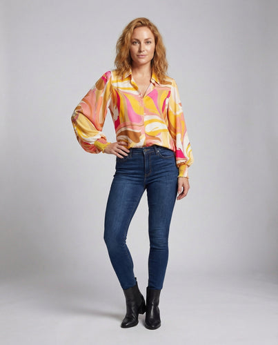 Women's fine knit sweater with side tie belt and boat neck.