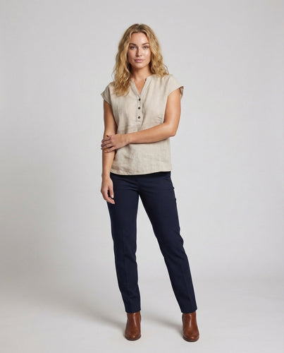 Women's stand-up collar blouse with decorative fabric button placket and graphic print.