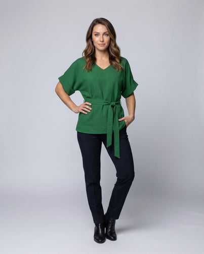Women high-waisted pants in palazzo style with gold decorative buttons.